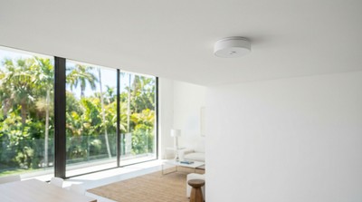 Glass break detection sensor on ceiling near large window in Florida home