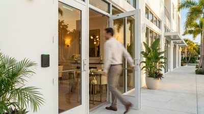 Alarm.com card reader at entrance of upscale Sarasota restaurant with employee walking through