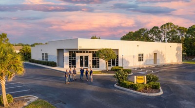 The Dehart team in front of their Sarasota headquarters at sunset
