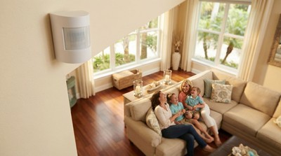 Motion detection sensor mounted on wall watching over family in Florida living room